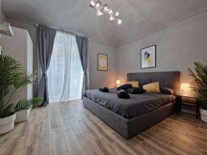 a bedroom with a bed and a large window at Casa Bonsai in Turin