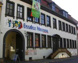 a building with a sign on the side of it at Halle, TOP -PREISE, große 79 qm SD FeWo, EG, wahlweise mit 1- 3 DZ, inklusiv TV Lounge, Küche, Bad WC Einfach und gut, Langzeitmieter VB Preise in Halle an der Saale