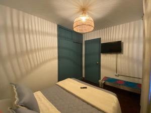 a bedroom with a bed and a light at Trip Monkey Chapinero in Bogotá