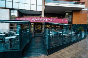 a restaurant with tables and chairs in front of a building at Amérian Executive Córdoba Hotel in Córdoba +24 photos
