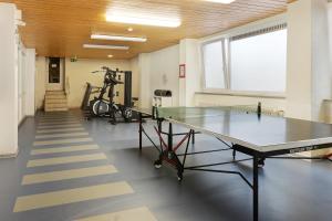 a ping pong table in a room with a gym at Ferienwohnung Sally in Lenzkirch