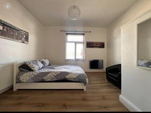 a bedroom with a bed and a television in it at Lana house in Birmingham