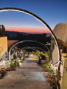 an archway over a walkway with potted plants at Karak House in Kerak