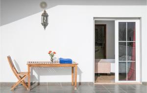 a table and a chair in a room at Villas Del Mar in Puerto Calero