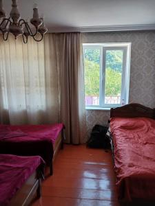 a room with two beds and a window at Guest house Track Kazbegi in Kazbegi