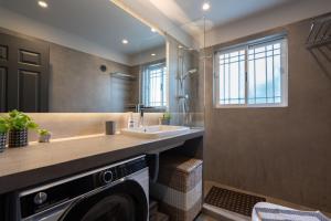 a bathroom with a sink and a washing machine at Seaside 2 Bedrooms Apartment in Glyfada in Athens