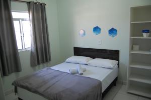 Säng eller sängar i ett rum på Hotel Pousada Pereira