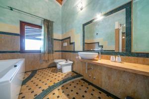 a bathroom with a sink and a toilet and a mirror at La Terrazza in Lessinia, Verona in Cerro Veronese