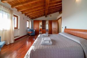 a bedroom with a large bed in a room at La Terrazza in Lessinia, Verona in Cerro Veronese