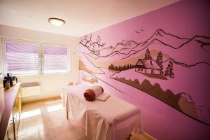 a room with two beds with a mountain mural on the wall at Hotel Bystrina in Belá +40 photos