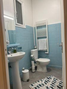 a blue bathroom with a toilet and a sink at Appartement Marseille centre Terrasse Vieux Port in Marseille