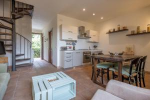 a kitchen and living room with a table and chairs at Al Frantoio in Corsanico-Bargecchia
