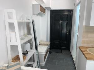 a bathroom with a toilet and a black door at Studio Sara in Iaşi +8 photos