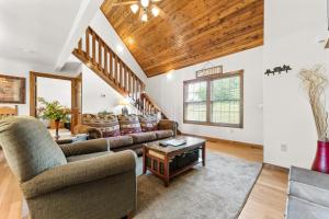 a living room with a couch and a table at Nestled Inn Lodge Home in Branson West