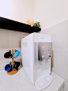 a kitchen with a coffee maker on a counter at Bali Residence Melaka Condo in Melaka +36 photos