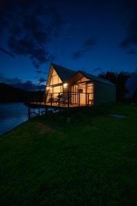 a house lit up at night with a dock at 5CHALETS in Guatapé