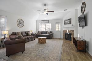 a living room with two couches and a fireplace at IAH Place: 4 bed, patio-sleeps 8+ in Humble