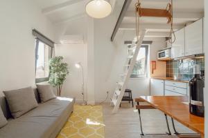 a living room with a couch and a ladder at Mezzanine Stylish Apartments by Vacationy in Porto