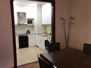 a kitchen with a table and a kitchen with a washer at The Wall Montevideo [203] Vive en la Ciudad Vieja in Montevideo