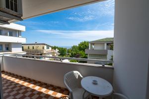 a balcony with a table and a chair and a view at Albergo Altamira in Roseto degli Abruzzi