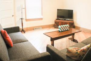 a living room with two couches and a coffee table at Comfortable Apartment - Pittsburgh's Little Italy in Pittsburgh