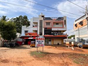 a building with a sign in front of it at ASSHAPPYSTAYINN HOTEL in Tiruchchirāppalli