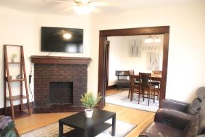 a living room with a fireplace and a tv at Comfy and Spacious 3 BR - Easy City Access in Pittsburgh