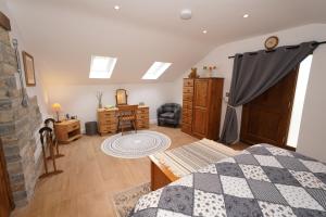 a bedroom with a bed and a desk at The Old Forge in Somerton