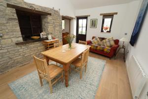 a living room with a wooden table and a couch at The Old Forge in Somerton