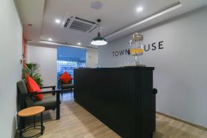 a lobby with a counter and chairs in a store at Super Townhouse Spruce Hotels Bellandur in Bengaluru