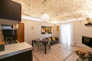 a kitchen and living room with a table and a couch at IamartinoApartments in Termoli