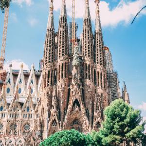 a cathedral with towers and trees in front of it at TOC Hotel Las Ramblas in Barcelona