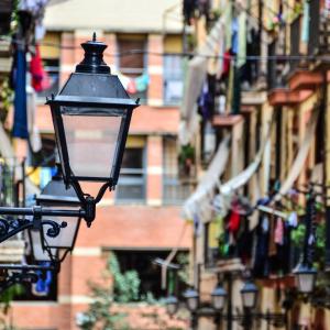 a street light in front of a building with flags at TOC Hotel Las Ramblas in Barcelona