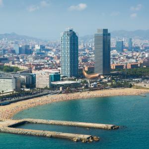 a beach with a group of people in the water at TOC Hotel Las Ramblas in Barcelona +35 photos