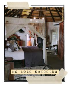 a bedroom with a bed with a no load shedding sign at Cranberry Cottage in Ladybrand