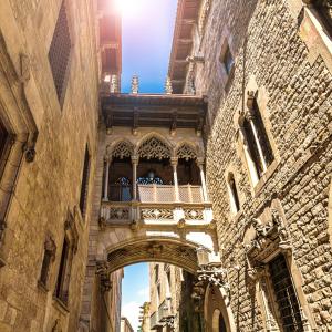 an old building with an arch and a balcony at TOC Hotel Las Ramblas in Barcelona