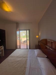 Postel nebo postele na pokoji v ubytování Hotel La Lampara