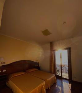 Postel nebo postele na pokoji v ubytování Hotel La Lampara