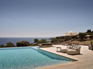 a swimming pool with a view of the ocean at Elle Lux Villa, Essence of Endless Blue, By ThinkVilla in Agios Nikolaos