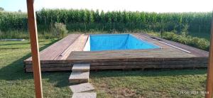 a swimming pool on a wooden deck in a yard at Casa Vacanze La Rosa e L'Ulivo in Faiti