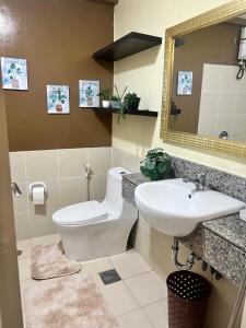 a bathroom with a toilet and a sink at Verdon Parc 2BR Condotel Trevans in Sanghay