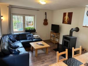 a living room with a couch and a stove at Rivendell 9 in Monschau