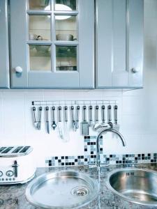 a kitchen with a sink and a counter with utensils at Dune Roamin': Sea Palling's Treasure - NOW with TV in Norwich