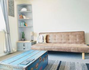 a living room with a couch and a coffee table at Dune Roamin': Sea Palling's Treasure - NOW with TV in Norwich