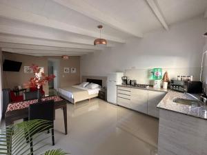 een keuken en een woonkamer met een bed in een kamer bij Cabaña de los Colibríes in Esquel
