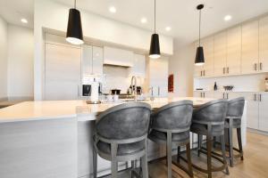 a kitchen with a bar with gray stools at JL802 Juniper Landing Jewel in Park City