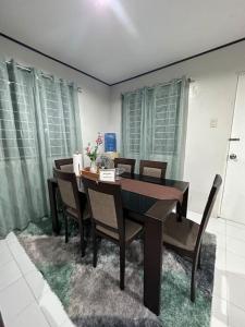 a dining room with a table and chairs at TymCast's Place - 2 Story house in Kabankalan