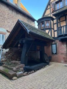 a building with a fireplace in front of it at Le Riquewihrien in Riquewihr