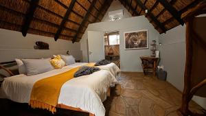 a bedroom with two beds in a room at Ohange Namibia Lodge in Otavi