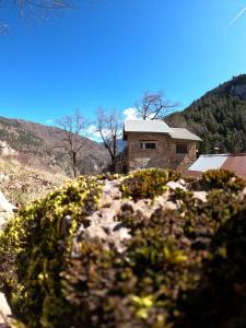 a stone house in the middle of a mountain at Maison Maralpine in Roubion